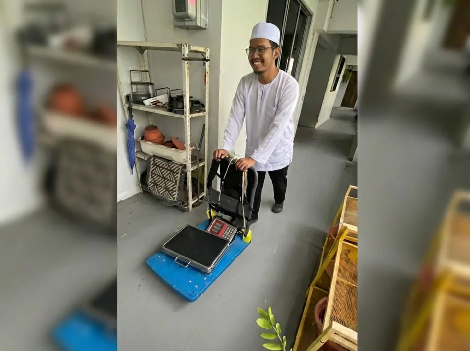Two ShredRite collectors at an HDB doorstep with a portable scale