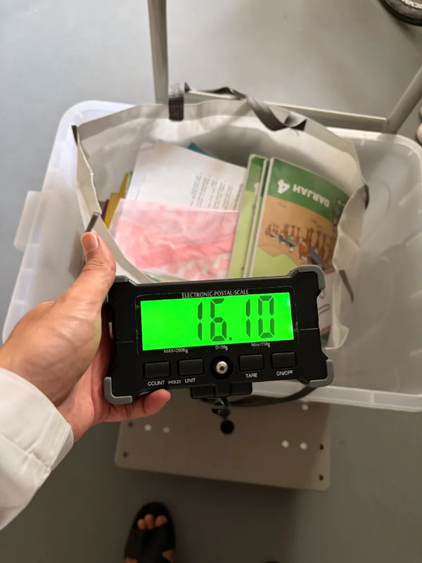 ShredRite team weighing books at a doorstep